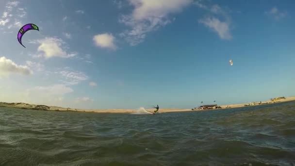 Advanced kiteboarder jumping high over the sun — Stock Video