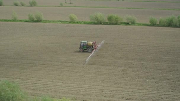 AERIAL: Tractor fertilizing the field in spring — Stock Video