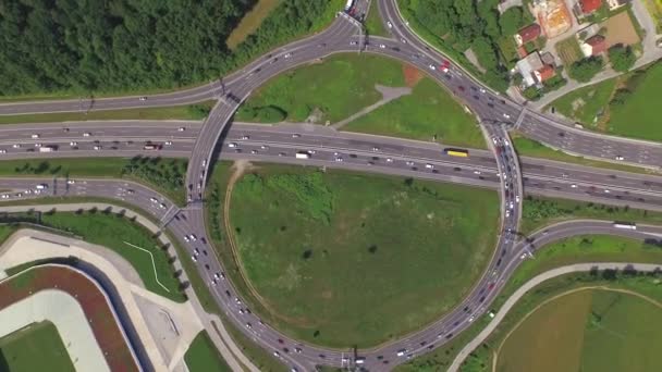 AERIAL: Four highways joining huge roundabout junction — Stock Video