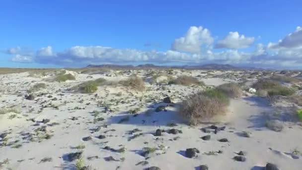 AERIAL: Volando sobre un vasto desierto de arena blanca hacia volcanes — Vídeo de stock