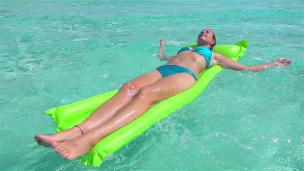 SLOW MOTION: Relaxed woman swimming on inflatable air bad floatie — Stock Video