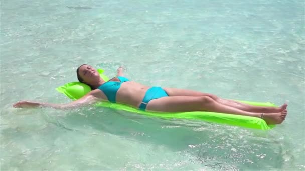 Slow Motion: gelukkige vrouw zon looien op opblaasbare luchtbed matras — Stockvideo