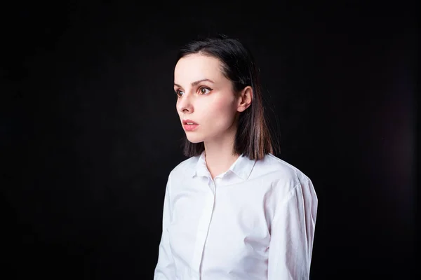 woman in white shirt on black background