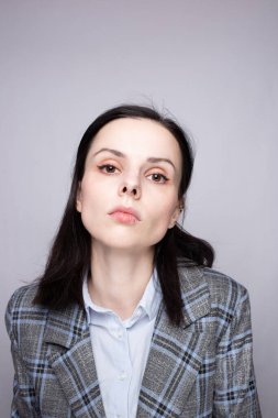 Gri arka planda takım elbiseli kadın yönetici