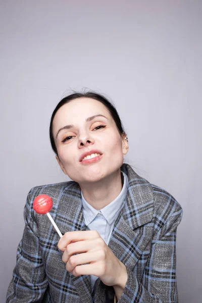Businesswoman Eating Lollipop Gray Background — Stock Photo, Image