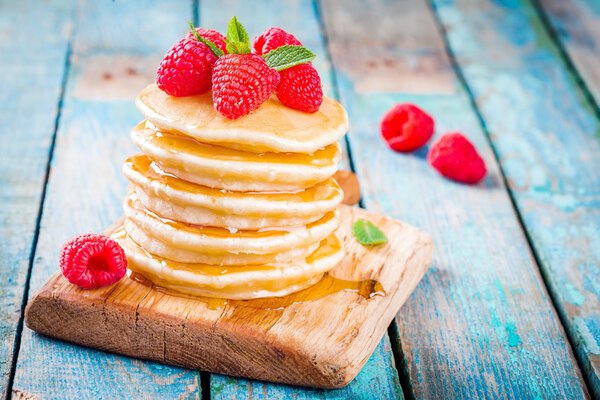 Homemade pancakes with honey and raspberry