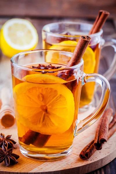 Hot tea with lemon, anise and cinnamon in glass mugs — Stock Photo, Image