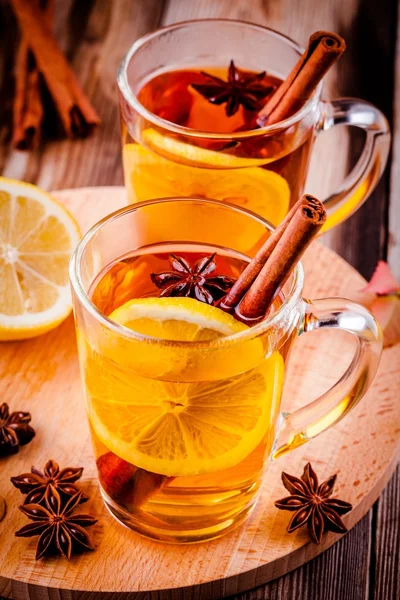 Hot tea with lemon, anise and cinnamon in glass mugs — Stock Photo, Image