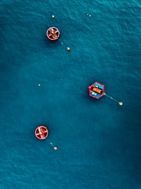 Aerial view of Blue Sea surface with red buoys