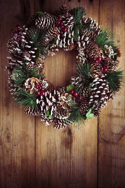 Christmas wreath on a rustic wooden door — Stock Photo, Image