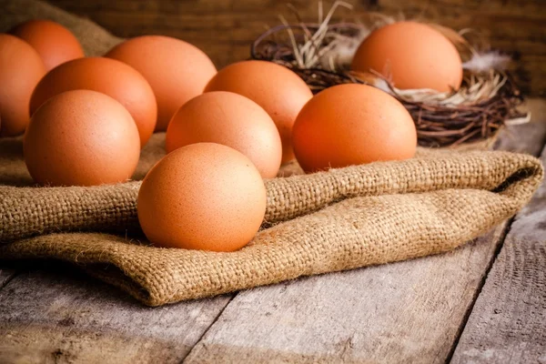 Fresh farm eggs on sacking — Stock Photo, Image