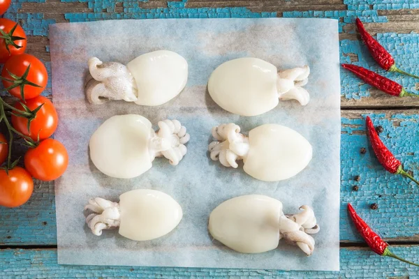 Raw babies cuttlefish  on  blue rustic background — Stock Photo, Image