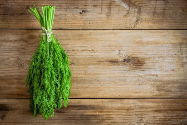 Bunch of fresh organic dill on  wooden background — Stock Photo, Image