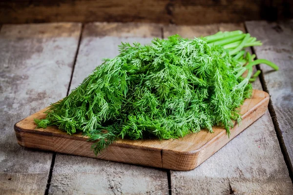 Massa färsk ekologisk dill på en skärbräda — Stockfoto