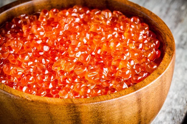 Fresh red caviar in a wooden bowl closeup — Stock Photo, Image