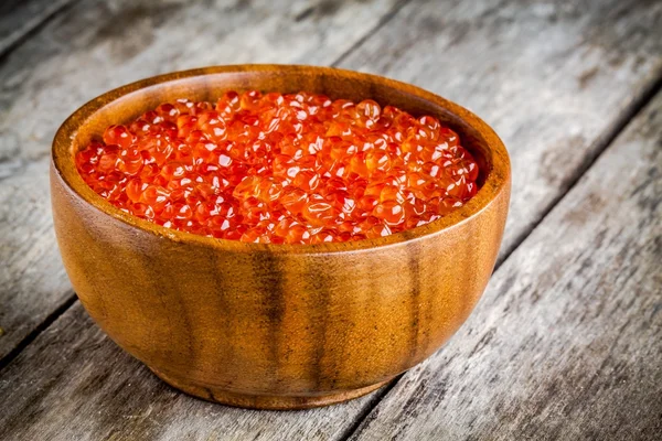 Fresh red caviar in a wooden bowl — Stock Photo, Image