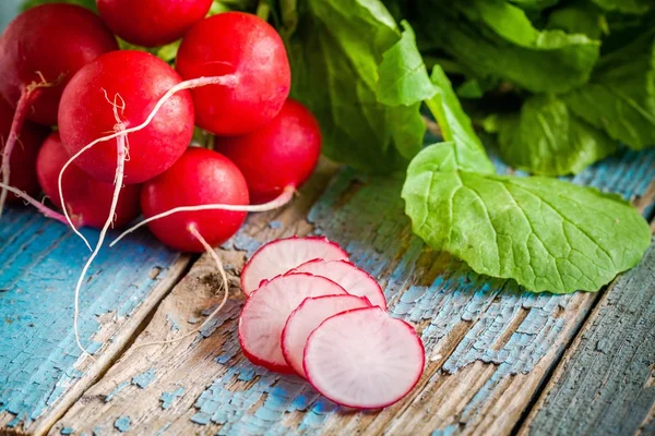 Bright fresh organic radishes with slices — Stock Photo, Image