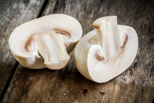 Raw champignons on a rustic table close up — Stock Photo, Image