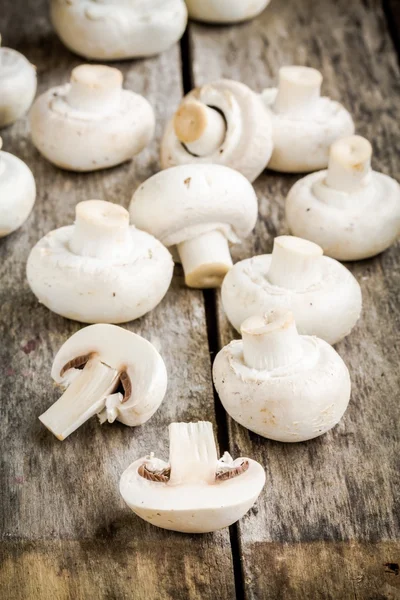 Raw fresh champignons on a wooden table — Stock Photo, Image