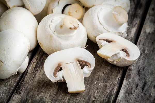 Raw champignons on a rustic table close up — Stock Photo, Image