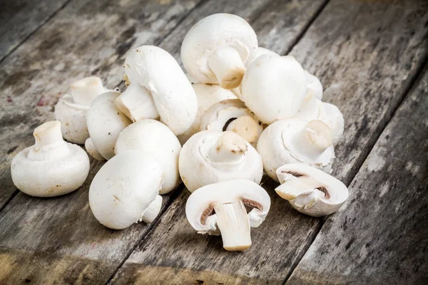 Raw fresh mushrooms on a wooden table — Stock Photo, Image