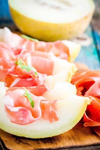 Melon with thin slices of prosciutto — Stock Photo, Image