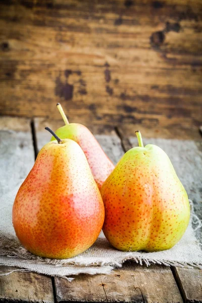 Three fresh ripe organic pears on a sacking — Stock Photo, Image