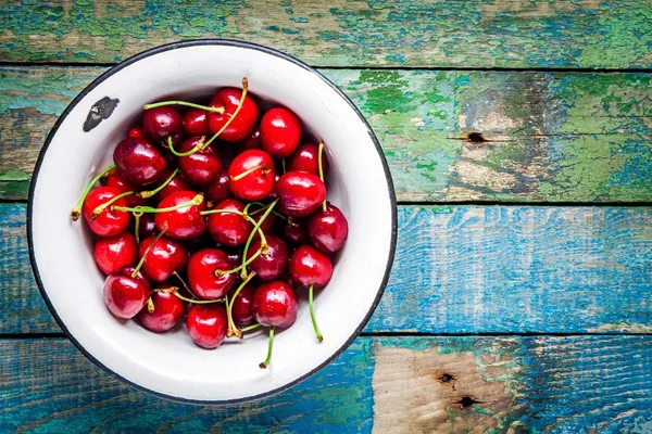 Cereza jugosa madura en un tazón viejo —  Fotos de Stock