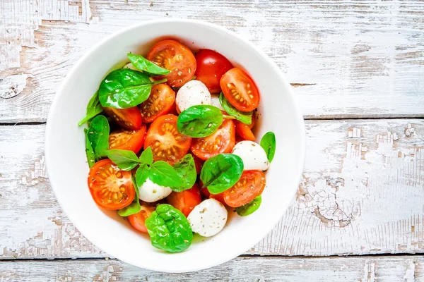 Salad of mozzarella, cherry tomatoes and spinach — Stock Photo, Image