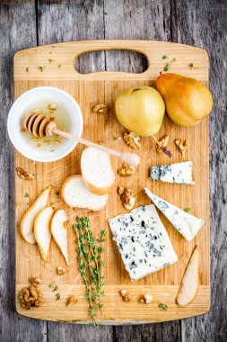 Mavi peynir dilimleri armut, fındık ve bal üstten görünüm ile