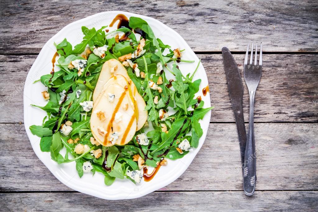 fresh salad with arugula, pear, walnuts and blue cheese