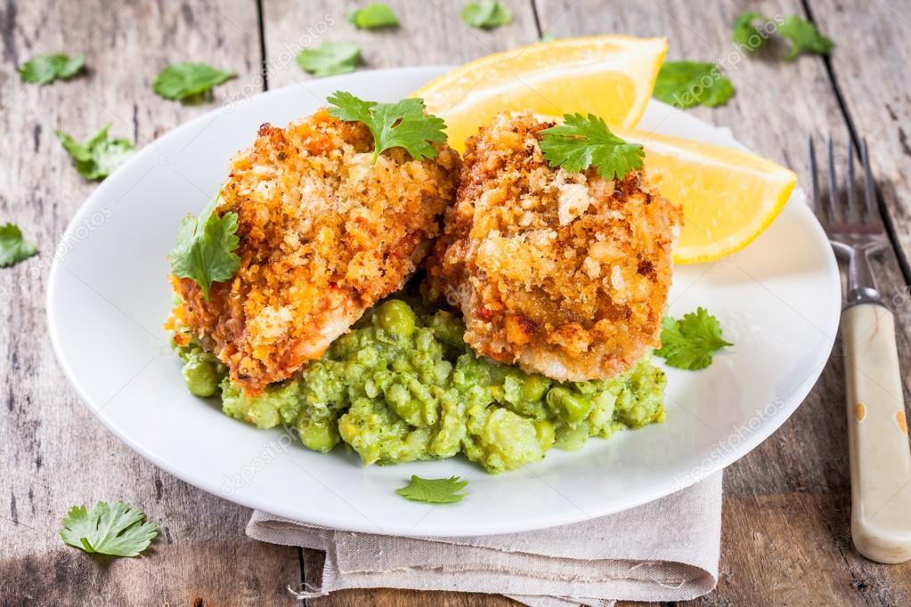 Baked cod fish in breadcrumbs with mashed green peas and broccoli Stock Photo by ©nblxer 85561666