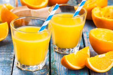 freshly squeezed orange juice in a glass with straws clipart
