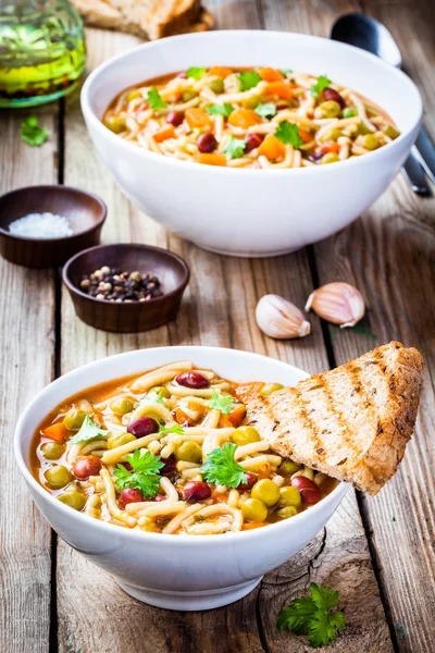 Minestrone soup with whole grain toasts — Stock Photo, Image