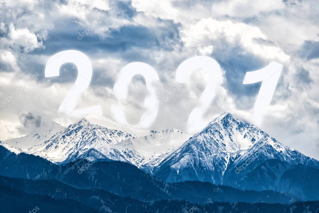 The 2021 figures rise from behind the snowy mountains. New Years coming concept