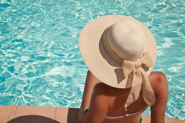 Mladá žena sedící na římse bazénu Royalty Free Stock Obrázky