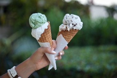 hand holding an ice cream cones clipart