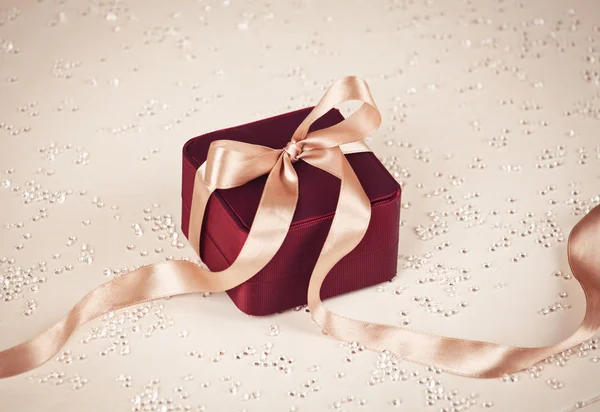 Luxury present on festive lighted background — Stock Photo, Image