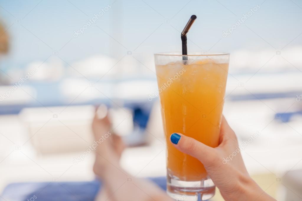 Woman Drinking Fruit Cocktail At The Beach