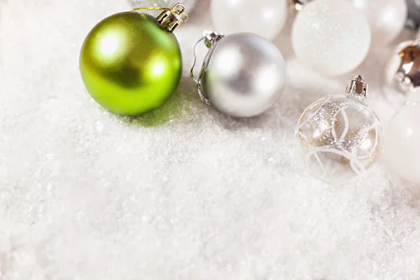 A Lot Of Baubles On Snowy Background — Stock Photo, Image