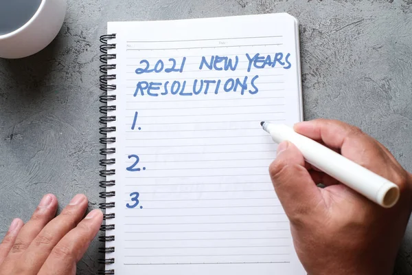 2021 resolutions, goals plans in life, business, close up of man writing and preparing for new year 2021