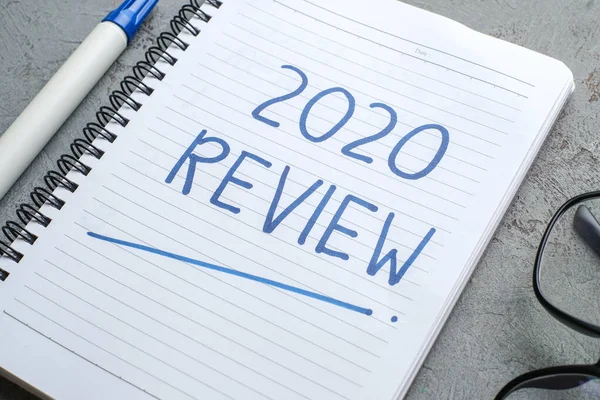 2020 Review; last year review in life; flat lay business concept. Writing and preparing for new year 2021 resolutions