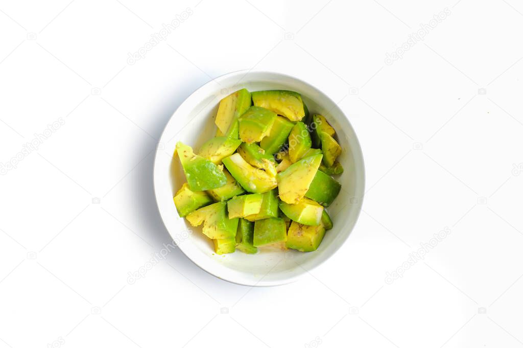 A Bowl of avocado slices isolated on white background