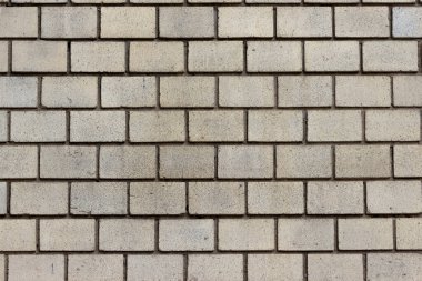 Sarı tuğla bir duvarın yüzeyi.