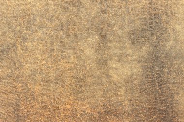 Yüzey eski sarı kadifeden, toz ve liflerle kaplı. Eski bir kitabın kirli, yıpranmış kapağı..