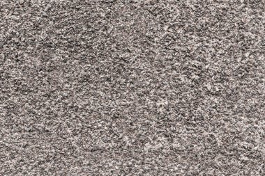Granit levhanın benekli yüzeyi ince benekli. Doğal taşın tekdüze dokusu.