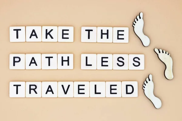 Path Less Traveled Letters Footsteps Beige Backgropund — Stock Photo, Image