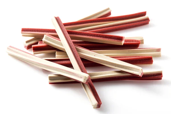 Yummy meat flavor dog treat sticks on background — Stock Photo, Image