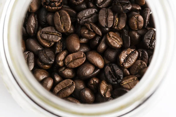 Färska kaffebönor i flaska, ovanifrån — Stockfoto