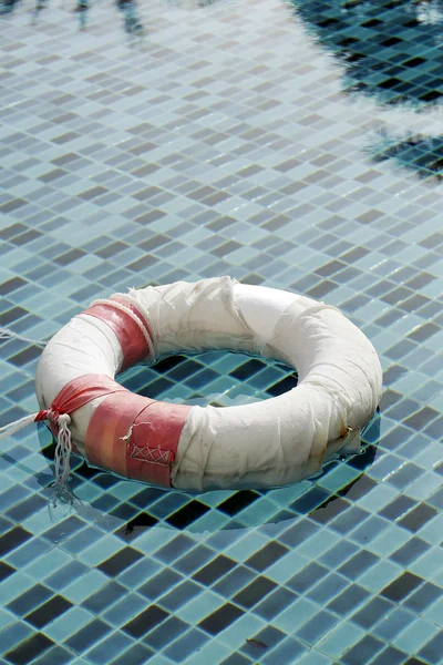 Old life buoy in swimming pool — Stock Photo, Image